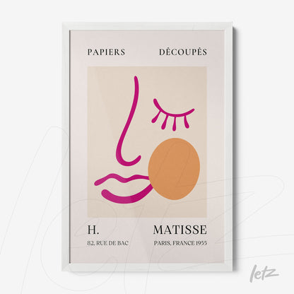 framed wall art featuring a minimalist illustration of a stylized face with pink and orange lines