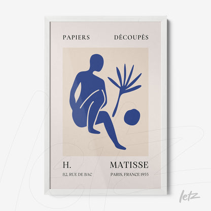 framed abstract art print of a blue human figure with botanical elements in a white frame
