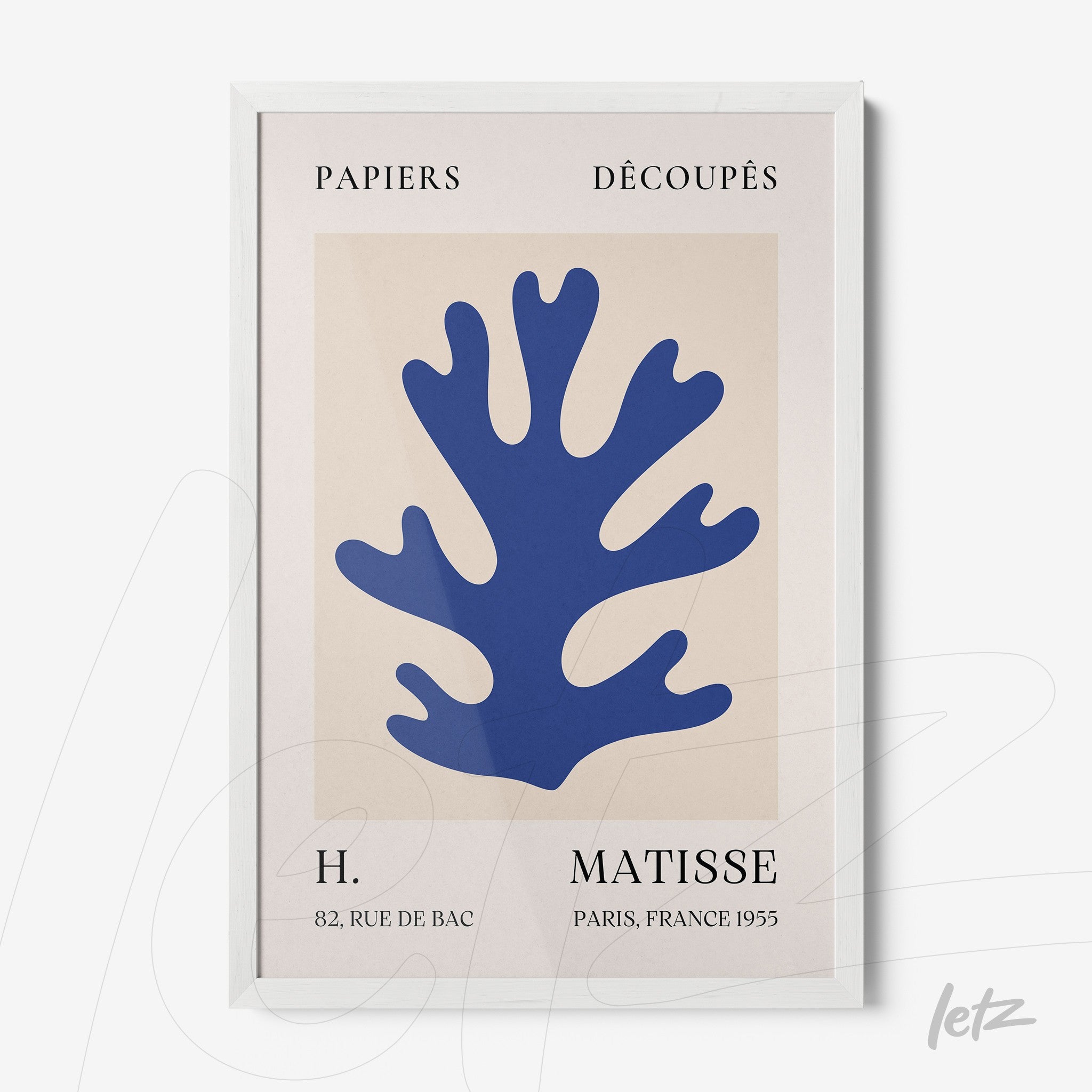 modern art framed piece featuring blue coral cutout on beige background with white frame