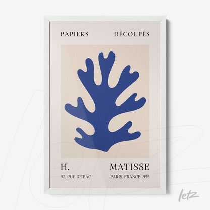 modern art framed piece featuring blue coral cutout on beige background with white frame