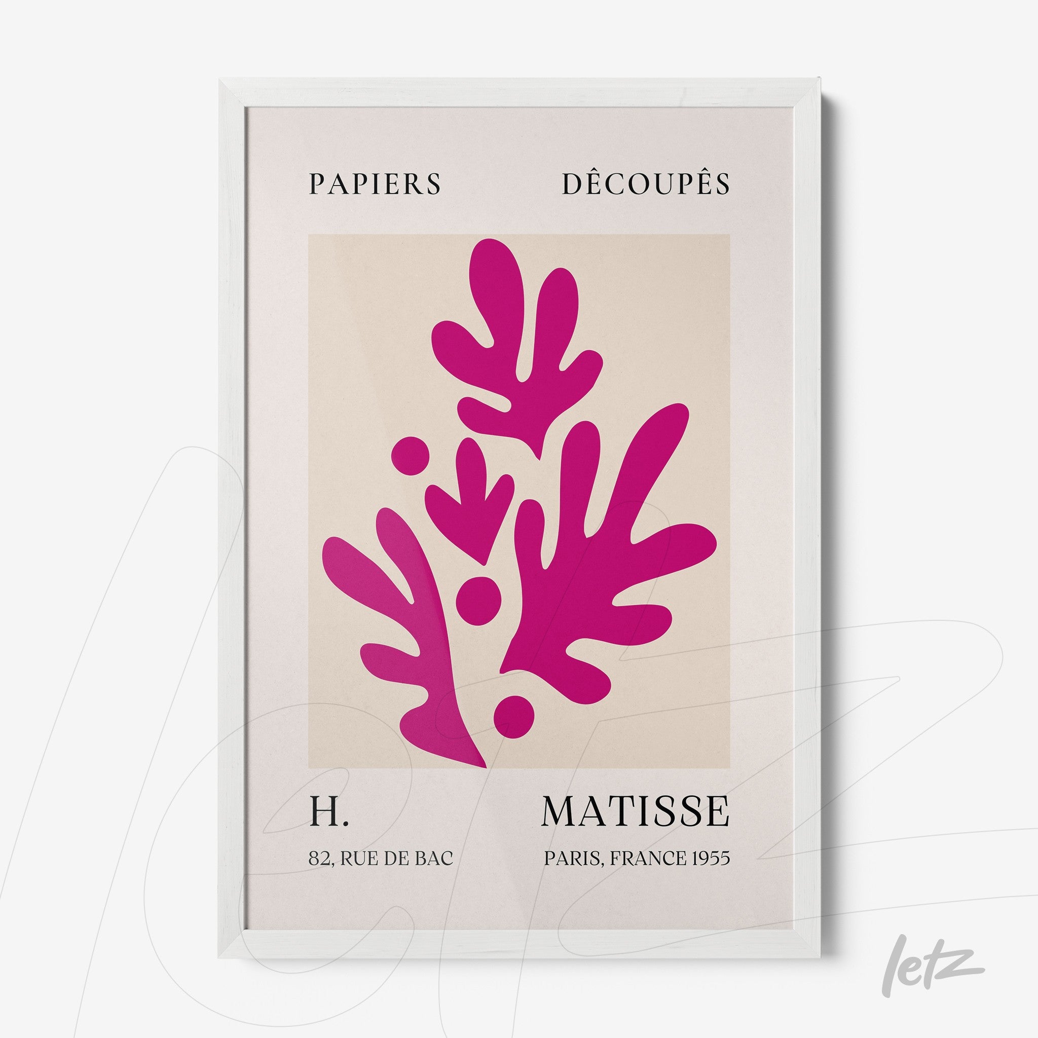 framed contemporary art of paper cutouts in pink on soft background with white frame