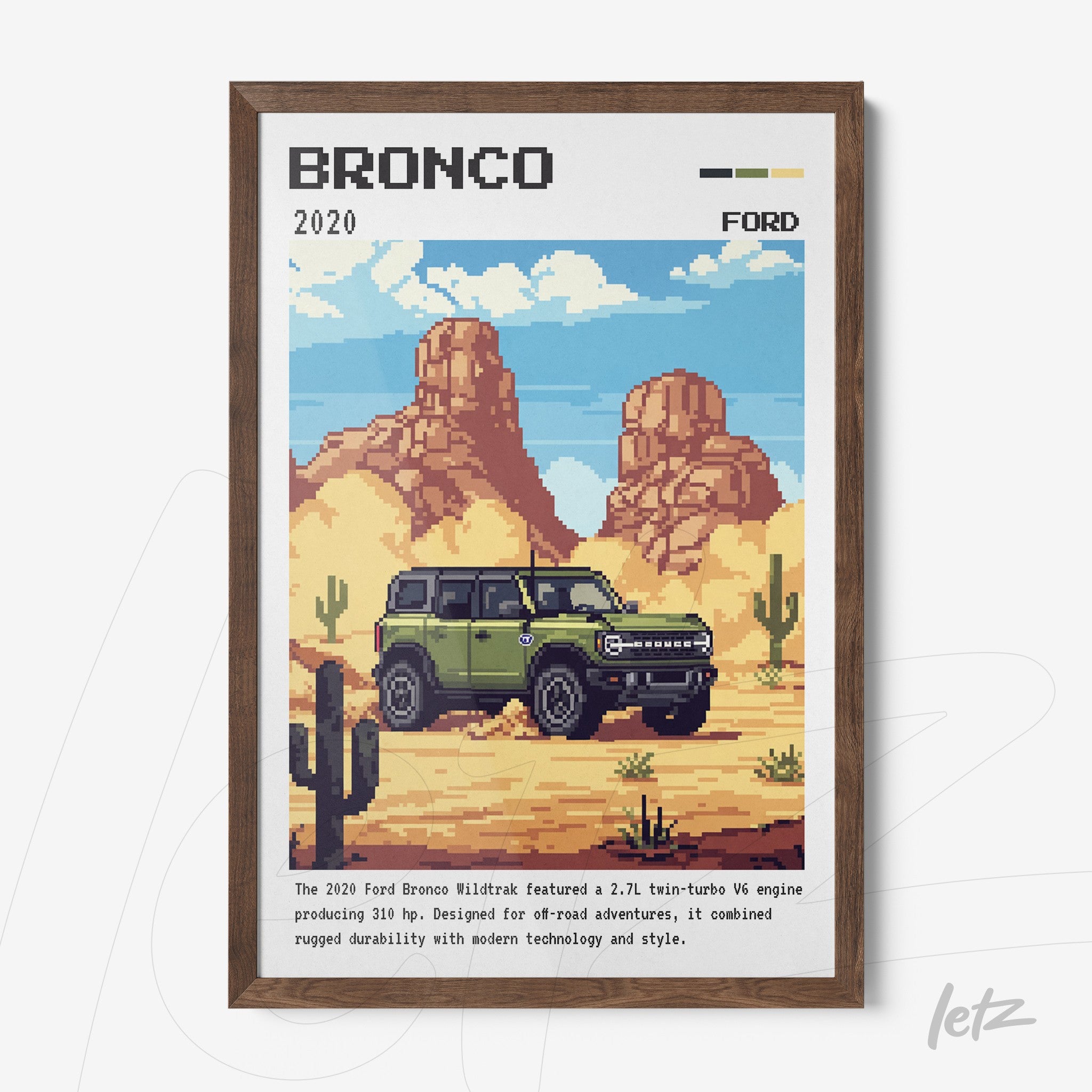 framed pixel art of a 2020 Ford Bronco in a desert landscape with cacti and mountains in the background, featuring a dark wood frame