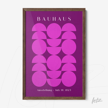 poster with geometric pattern in shades of pink framed in dark wood