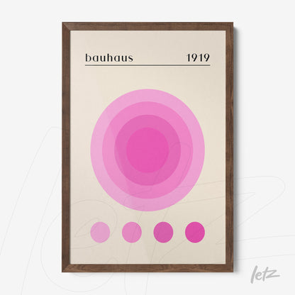 poster print featuring concentric circles in shades of pink on a light background framed in dark wood