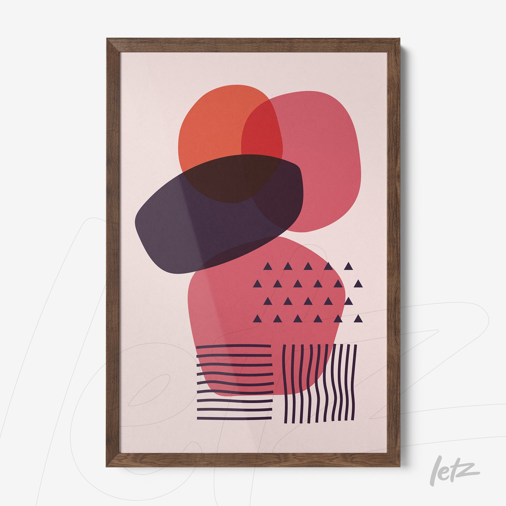 abstract geometric art with overlapping shapes in red and purple tones, framed in dark wood