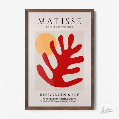 modern wall art featuring a vibrant red stylized leaf and a yellow background, framed in dark wood
