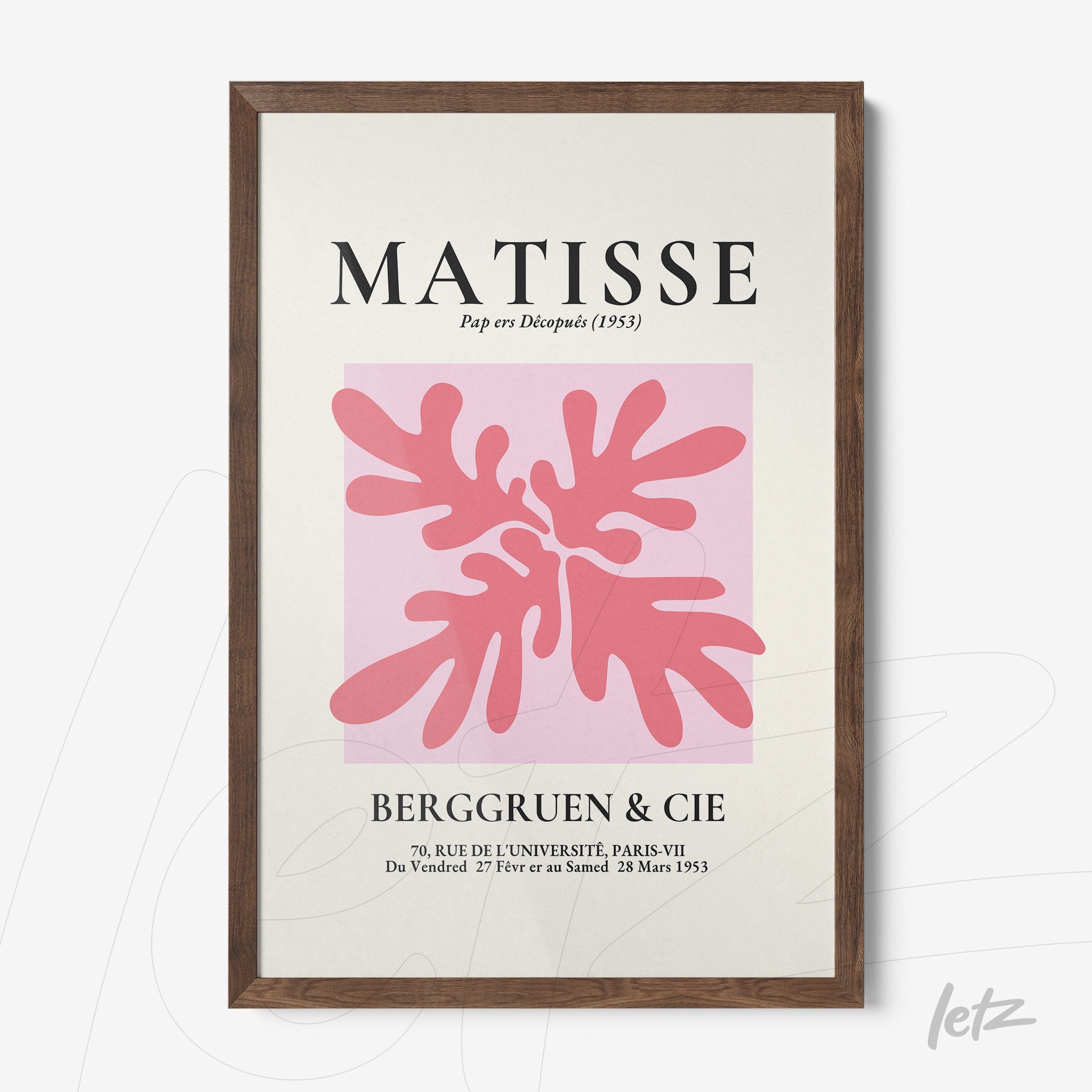 framed modern art print of coral leaves in pink against a light pink background with dark wood frame
