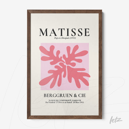 framed modern art print of coral leaves in pink against a light pink background with dark wood frame