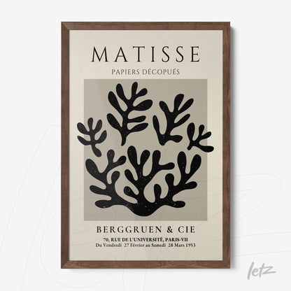 framed wall art featuring paper cutouts in modern style with dark wood frame
