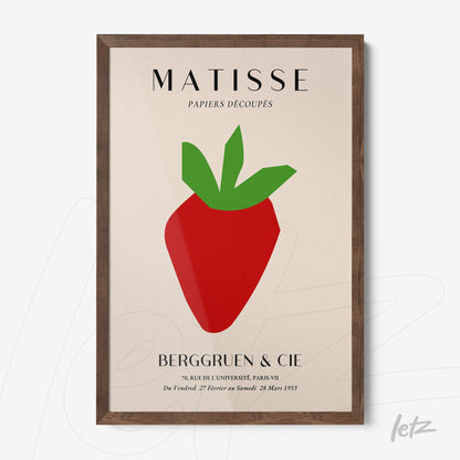 framed modern artwork featuring a red strawberry with green leaves set in a dark wood frame