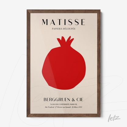 framed art print featuring a stylized cut-out of a pomegranate in a light background with dark wood frame