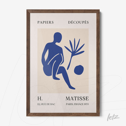framed modern art in blue depicting a seated figure and plant with dark wooden frame