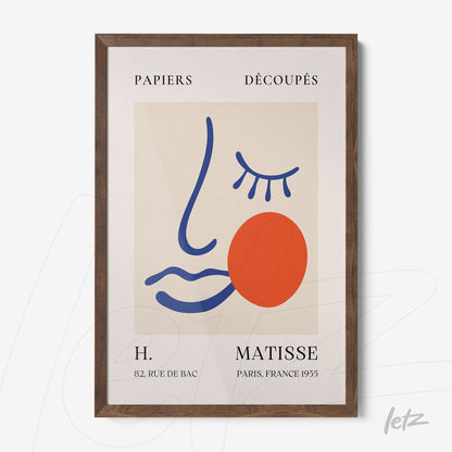 framed modern art piece featuring a stylized face with geometric shapes in vibrant colors and dark wood frame