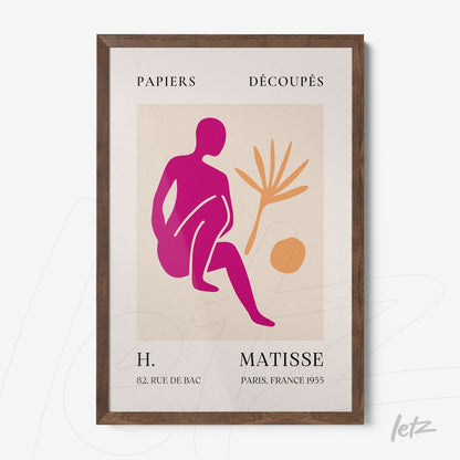 framed wall art featuring an abstract figure in pink and orange hues, with palm tree details and light wooden frame