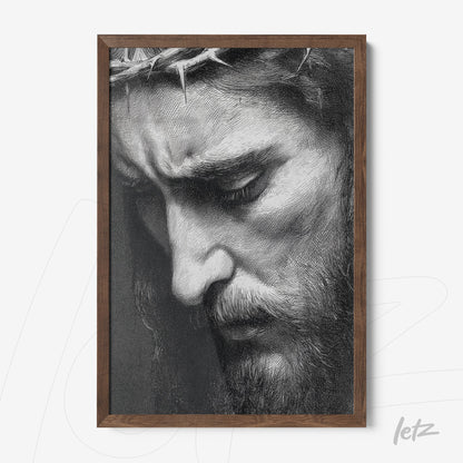 framed black and white portrait of Christ with a contemplative expression and dark wood frame