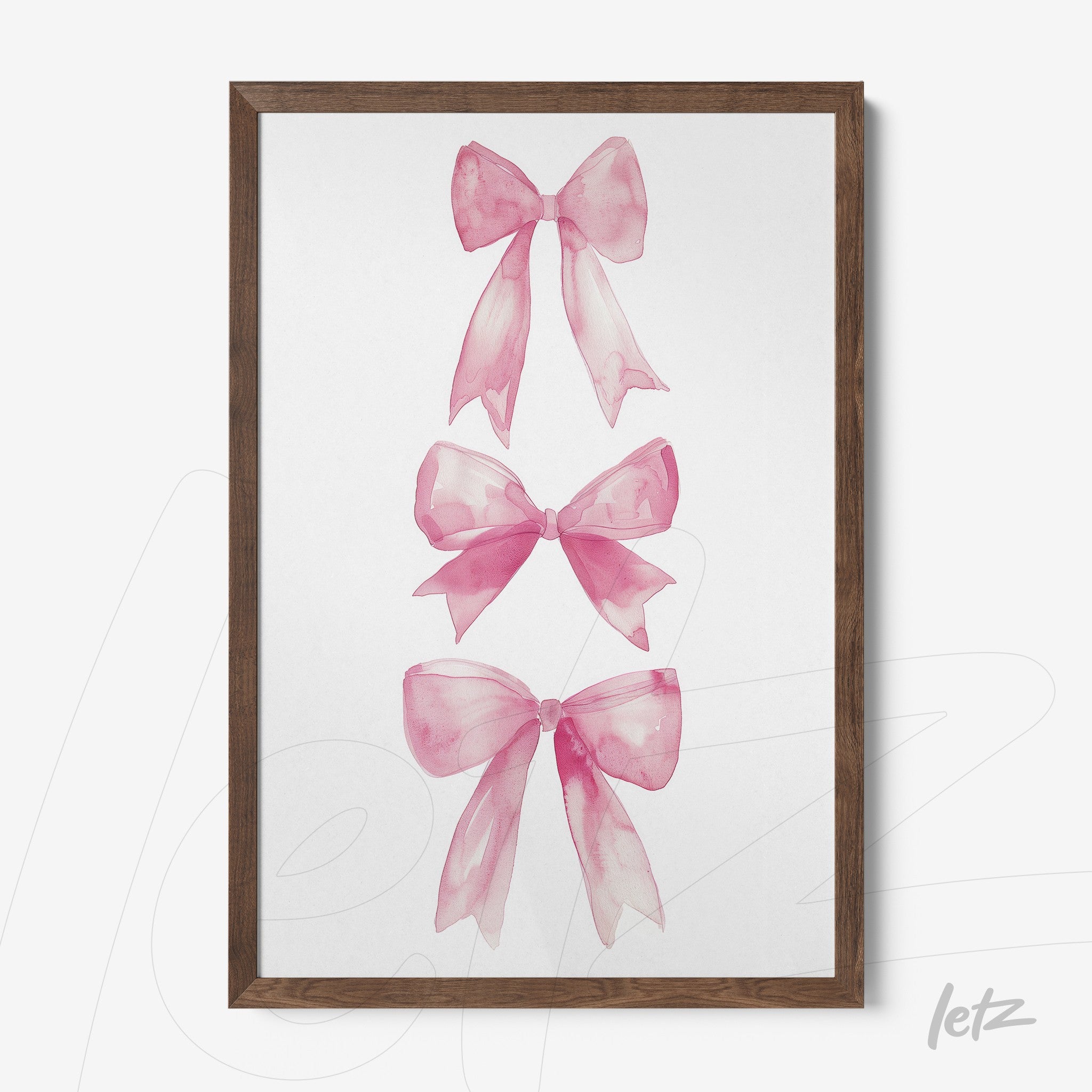 framed artwork featuring three pink watercolor bows in a dark wood frame