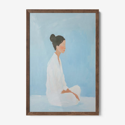 framed artwork of a woman in a meditative pose with dark wood frame and soft blue background
