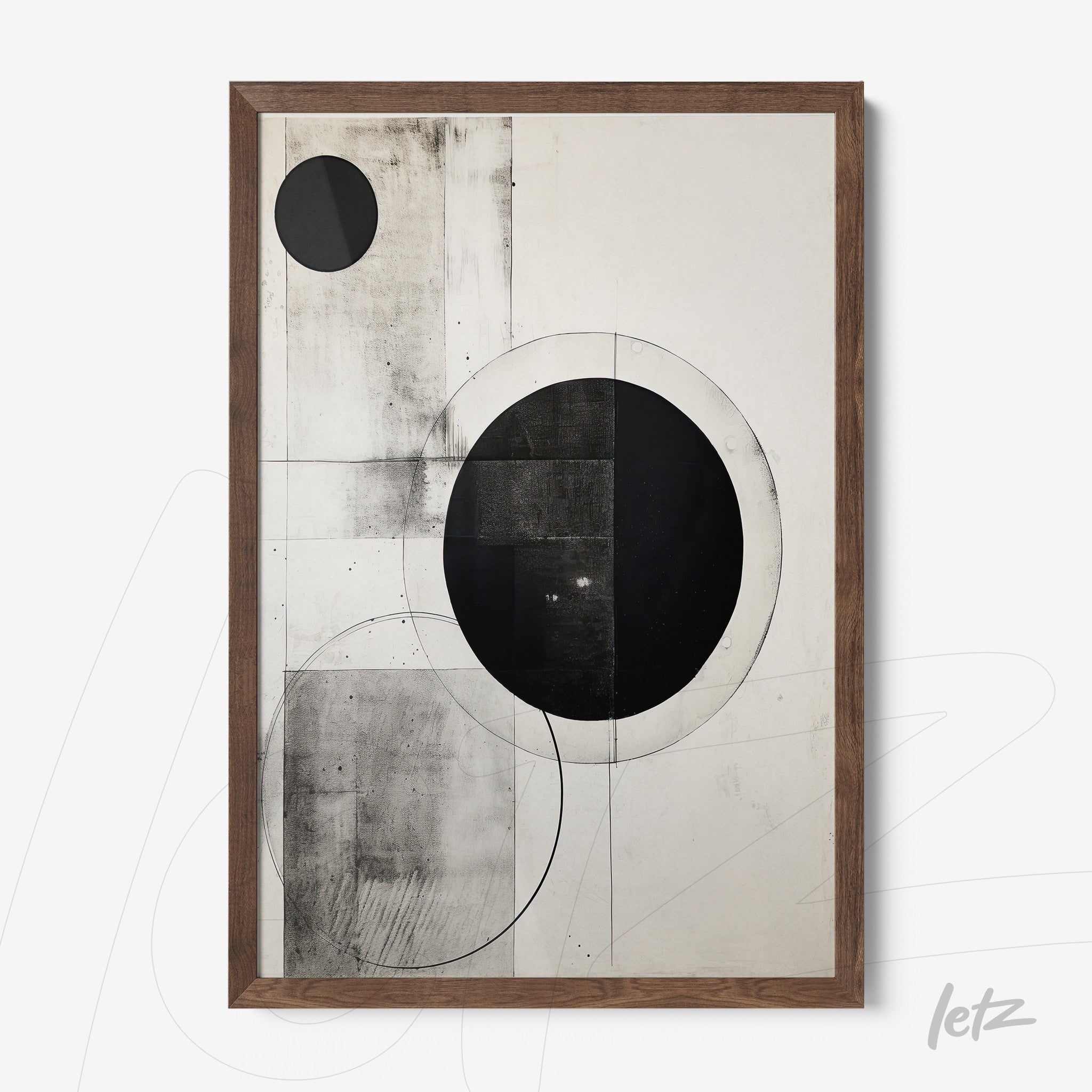 abstract wall art featuring black and white geometric circles on a light background with a dark wood frame
