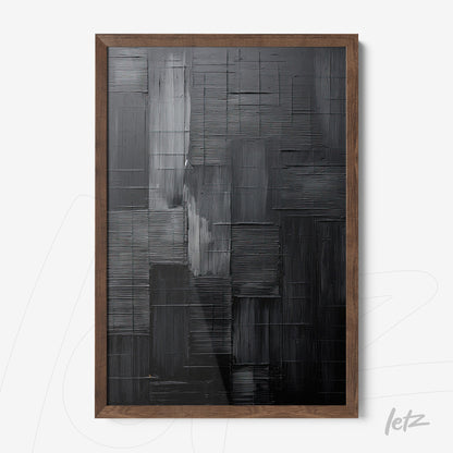 abstract wall art in shades of black and gray with bold texture, framed in dark wood frame