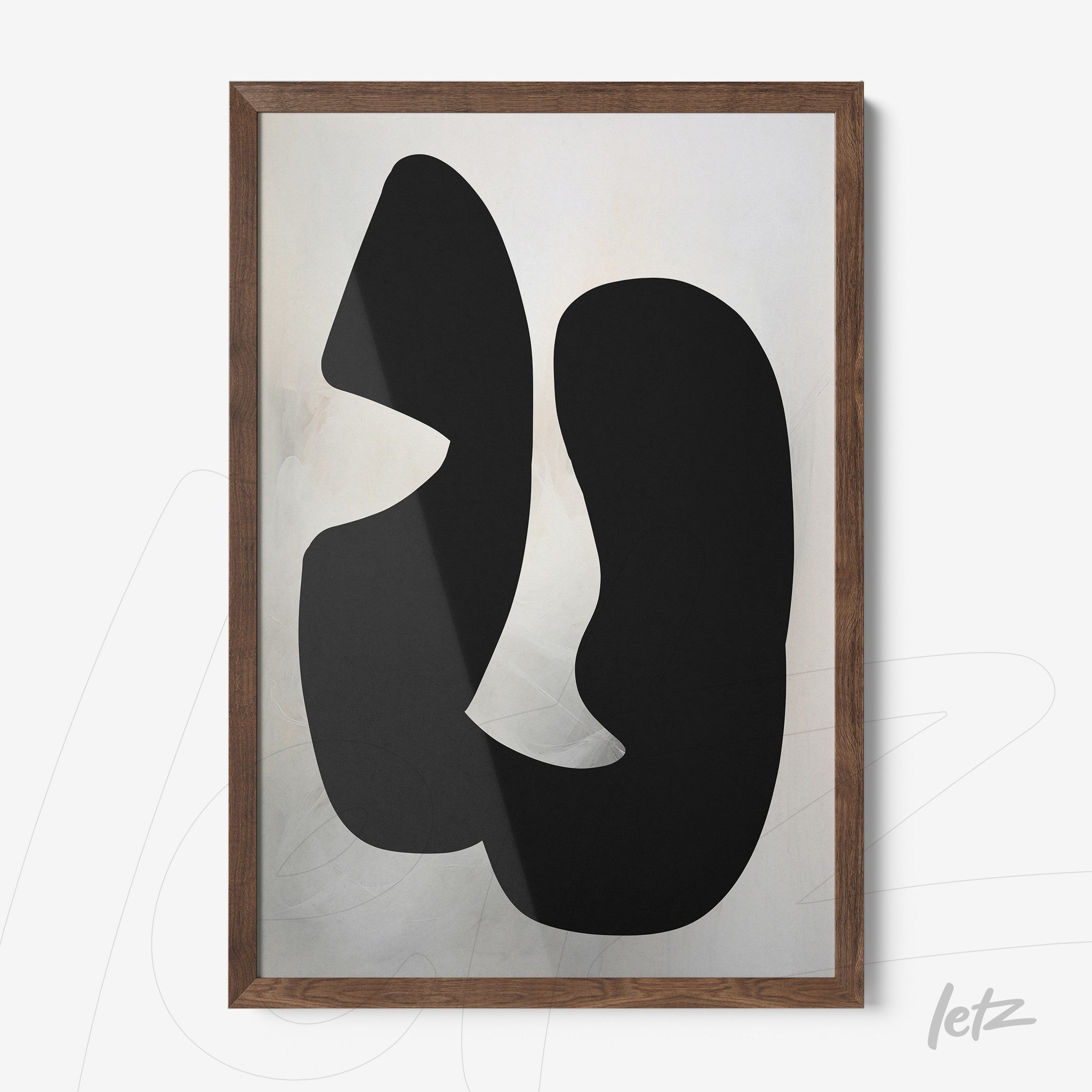 abstract wall art featuring black shapes on a light background with a dark wood frame