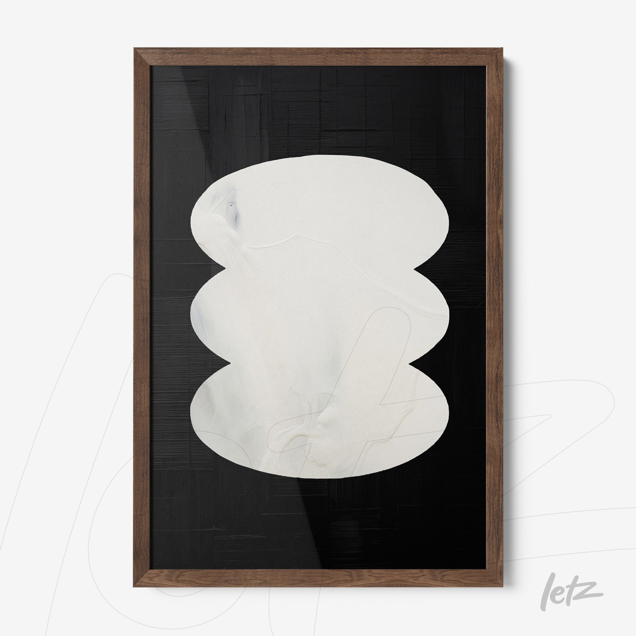 abstract wall art in white and black hues featuring a wooden dark frame