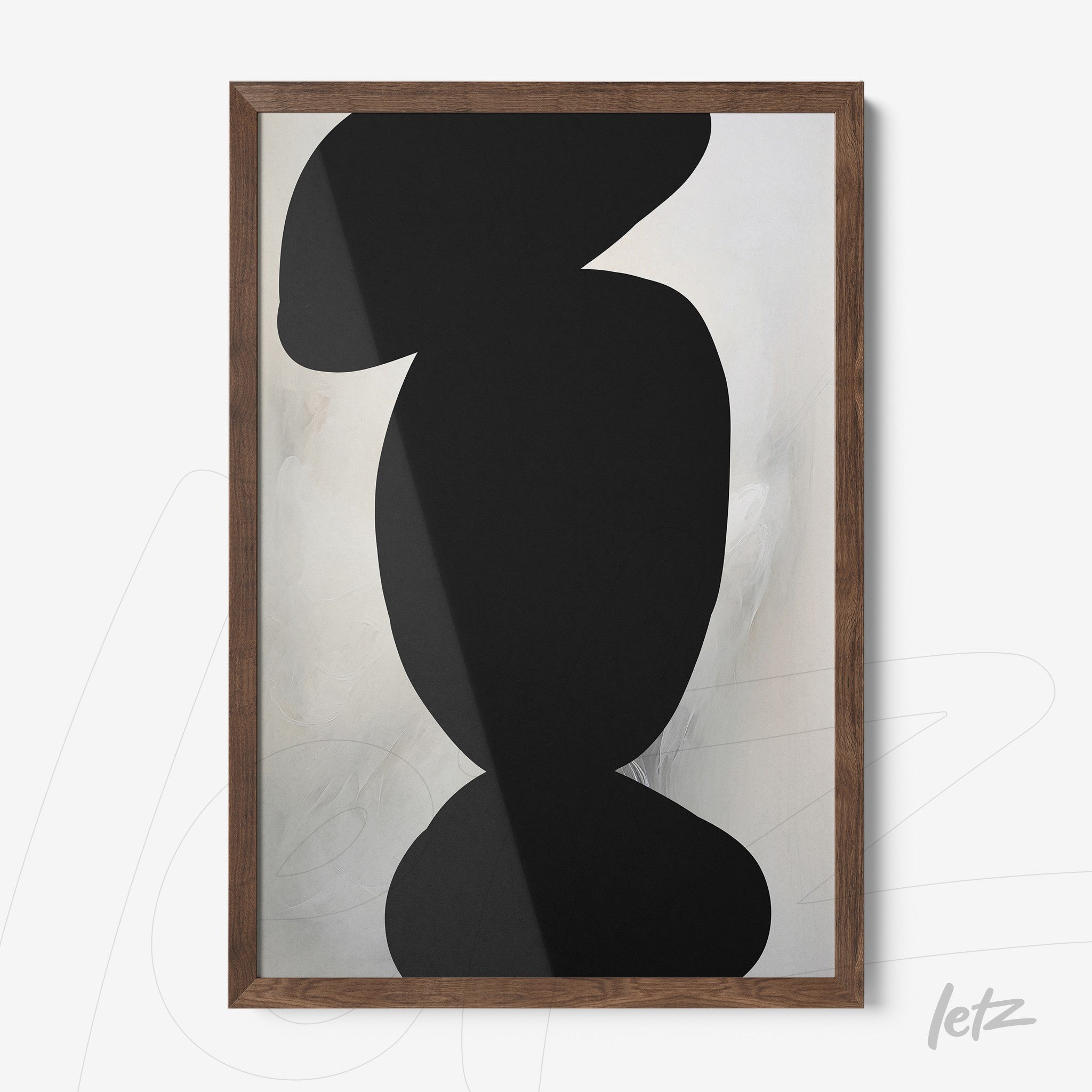abstract wall art in black over soft light-colored background with dark wooden frame