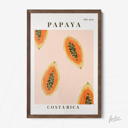 framed artwork featuring papaya illustrations on a pink background with dark wood frame