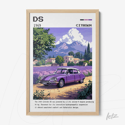 framed digital art of a 1969 Citroën DS in a colorful scene with mountains in the background and lavender field, light wood frame