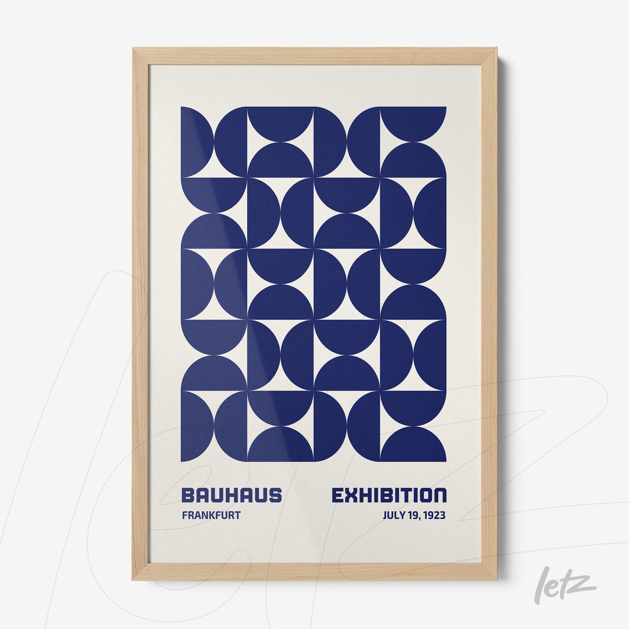 poster with blue geometric design in light wood frame