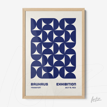 poster with blue geometric design in light wood frame