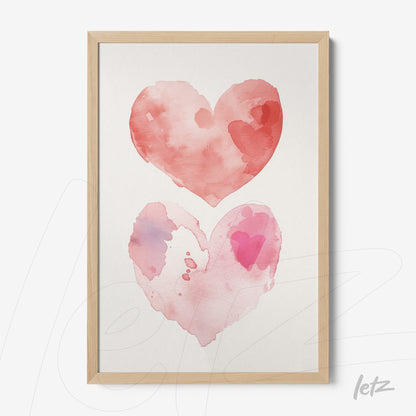 framed watercolor art of two pink hearts with soft hues on light background, set in light wooden frame