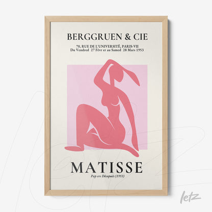 framed wall art showcasing a warm-colored illustration of a relaxed female figure with light wood frame and white background