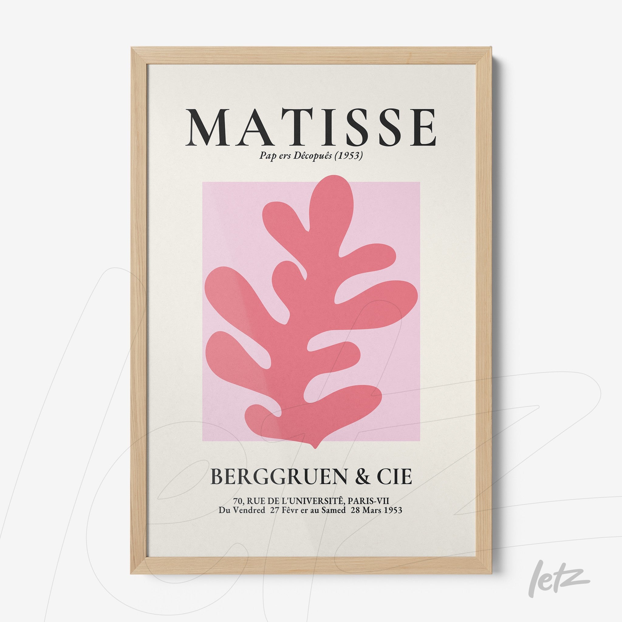 framed art print featuring a stylized pink leaf on cream background with light wood frame