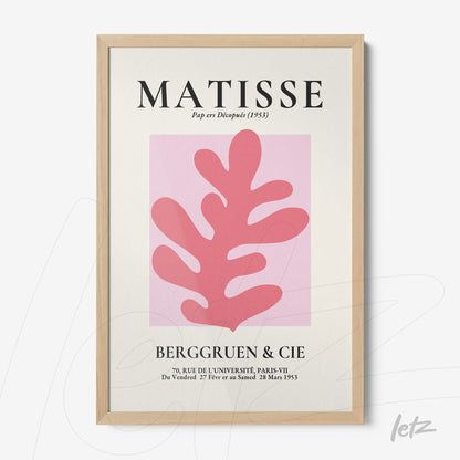 framed art print featuring a stylized pink leaf on cream background with light wood frame