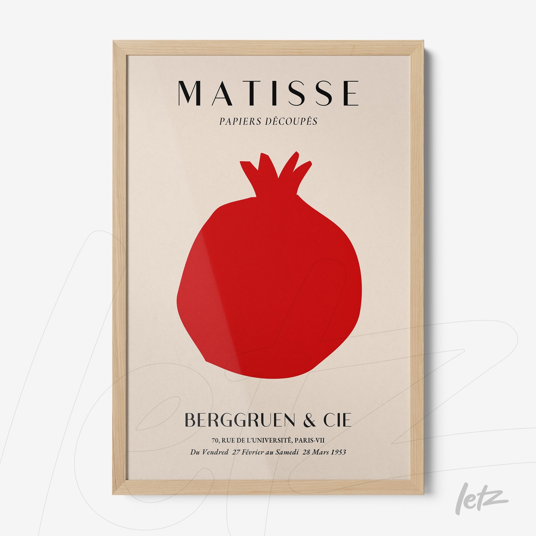 framed modern art featuring a solid red pomegranate, displayed with a light wood frame and white background