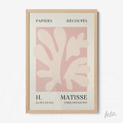 framed wall art featuring modern design with organic shapes in soft tones on light pink background with light wood frame