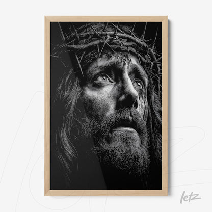 framed black and white portrait of a man with a crown of thorns in light wood frame