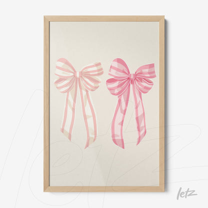 framed wall art featuring pink bows illustration in light wood frame