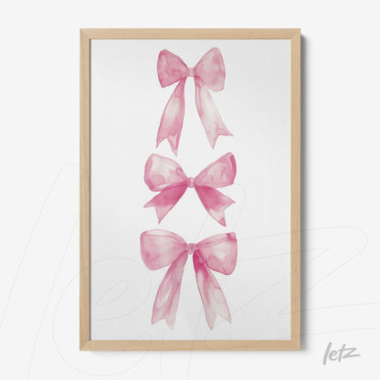 framed wall art featuring three watercolor pink bows with light wood frame