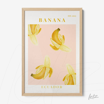 framed wall art featuring yellow bananas on a pink background with light wood frame and text 'BANANA ECUADOR EST. 2023'