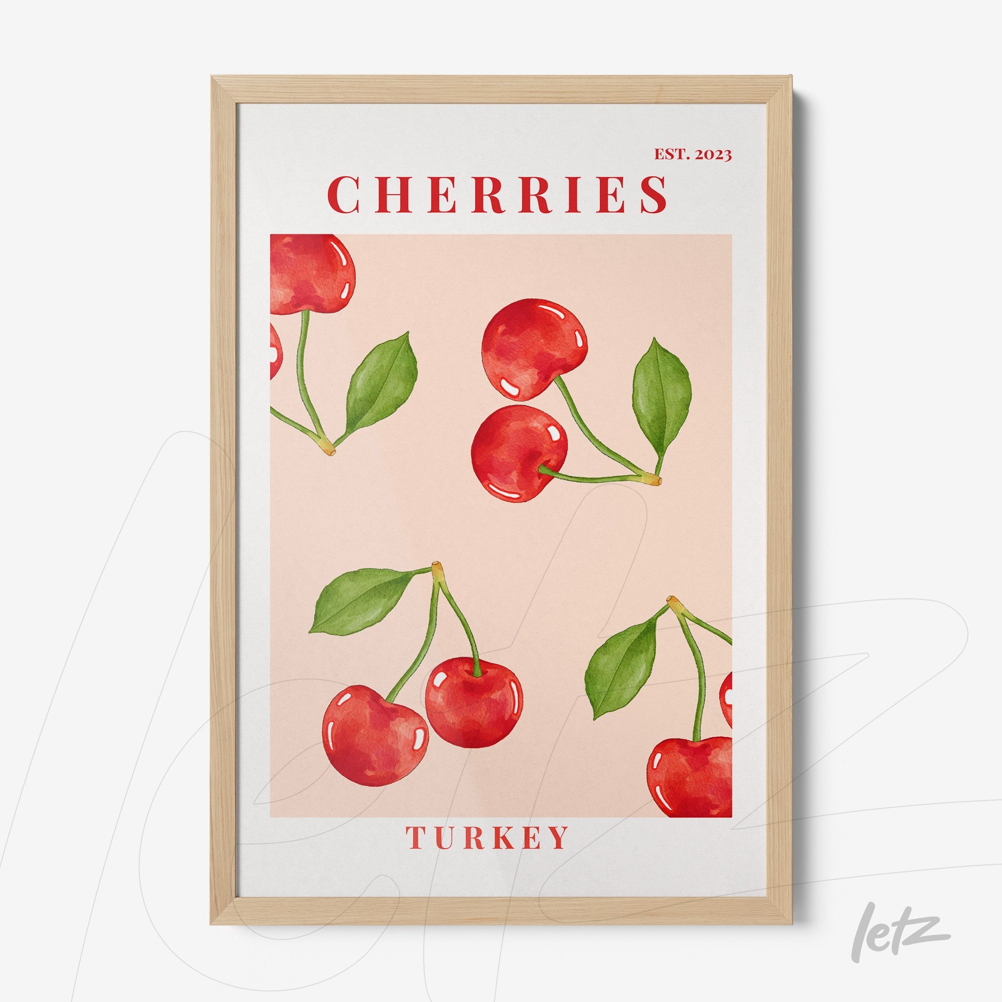 framed wall art featuring red cherries illustration on pink background with light wood frame and stylized text