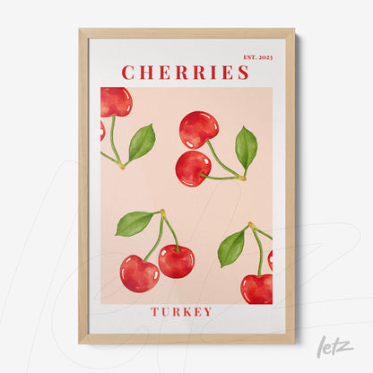 framed wall art featuring red cherries illustration on pink background with light wood frame and stylized text