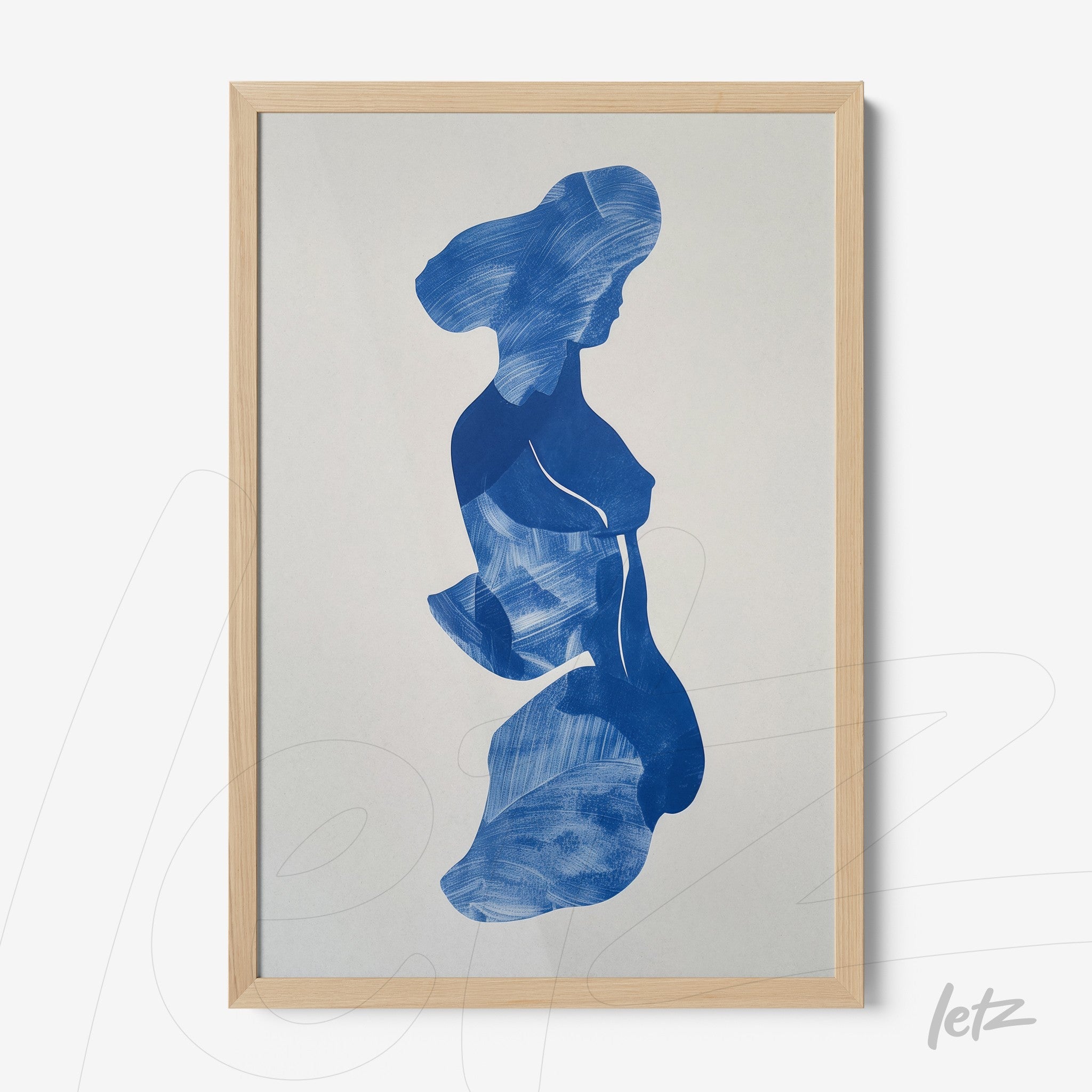 framed artwork featuring an abstract blue silhouette of a female figure on a light background with a light wood frame