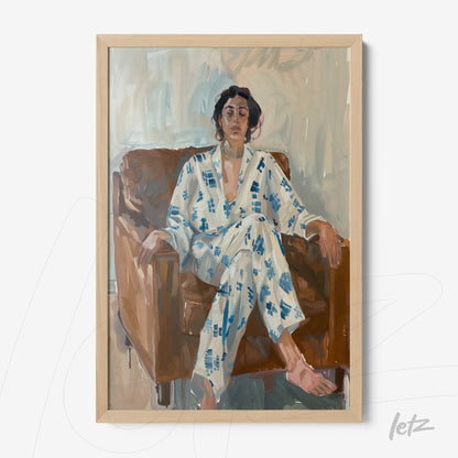 framed artwork of a woman sitting on a sofa wearing a blue and white pajama, light wood frame