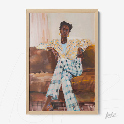 framed art depicting a seated woman in a yellow floral blazer and checkered pants with a light wood frame