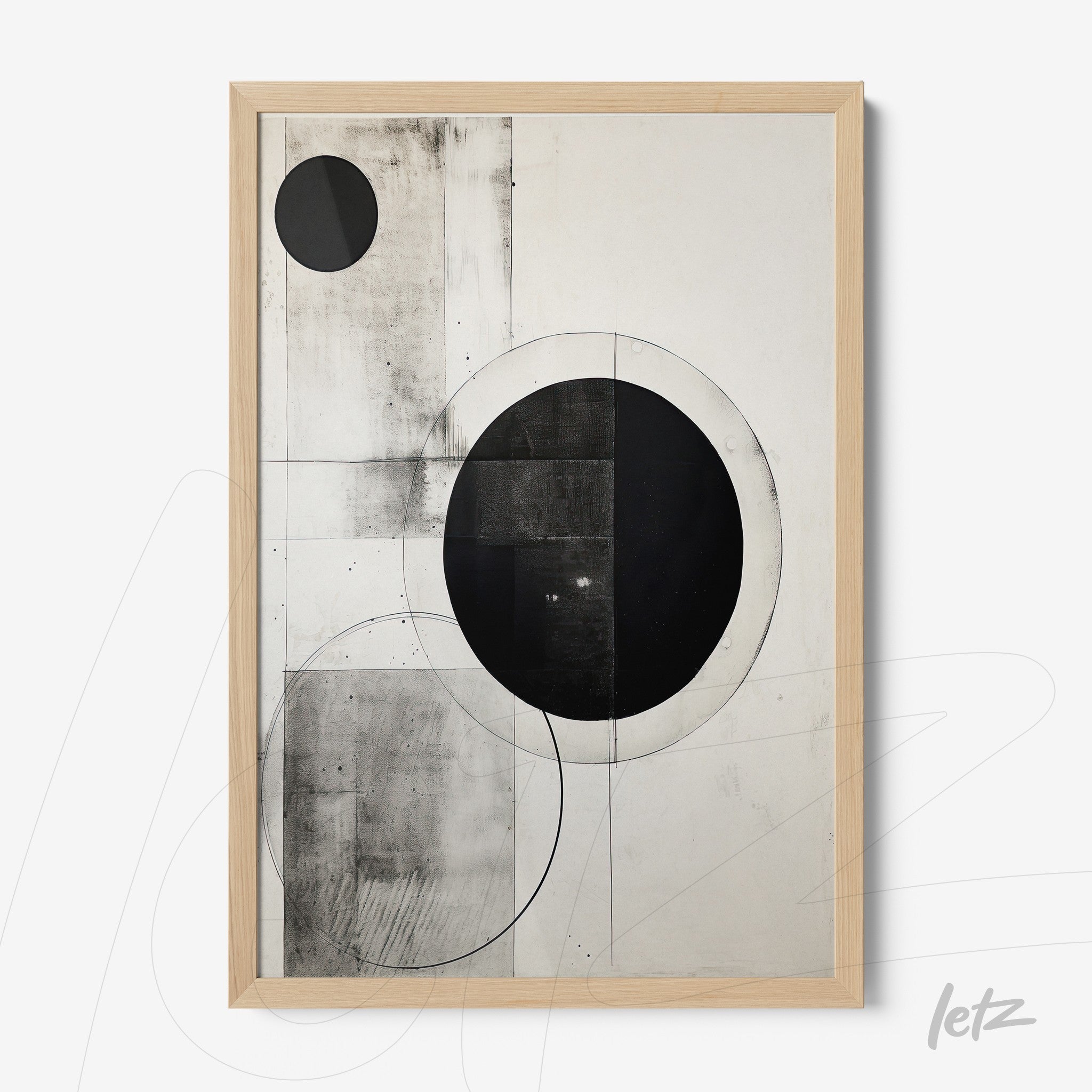 abstract wall art in black and white featuring prominent circular shapes with a light wood frame