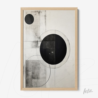 abstract wall art in black and white featuring prominent circular shapes with a light wood frame
