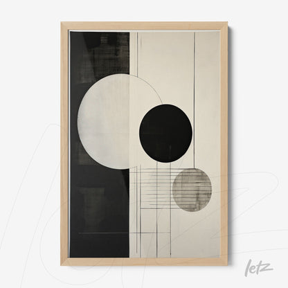 abstract wall art in black and cream tones featuring circles on a smooth background with light wood frame