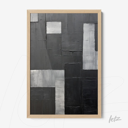 modern artwork in shades of black and gray with thick paint textures in light wood frame