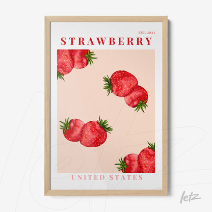 framed wall art featuring illustrative strawberries on a pink background with light wood frame